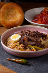 pilaf with meat, tomato salad and bread