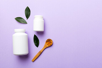 supplement pills with medicine bottle health care and medical top view. Vitamin tablets. Top view mockup bottle for pills and vitamins with green leaves, natural organic bio supplement, copy space