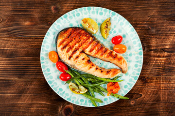 Grilled trout steak on a plate.