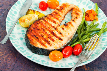 Plate of grilled salmon steak.