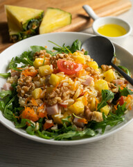 Rice salad with pineapple, walnuts and arugula.