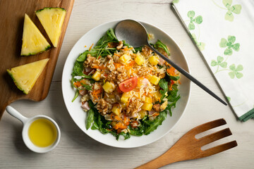 Rice salad with pineapple, walnuts and arugula.
