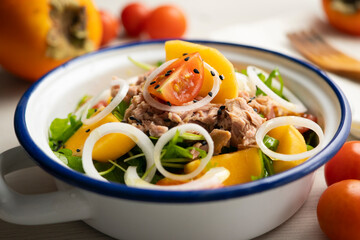 Persimmon, tomato, onion and tuna salad.