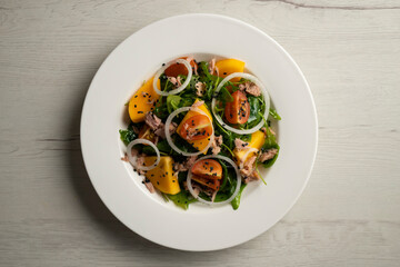Persimmon, tomato, onion and tuna salad.