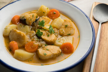 Hake stew with potatoes and carrots. Traditional Spanish recipe.
