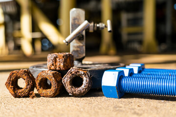 New and old threaded nuts used in the petroleum industry.