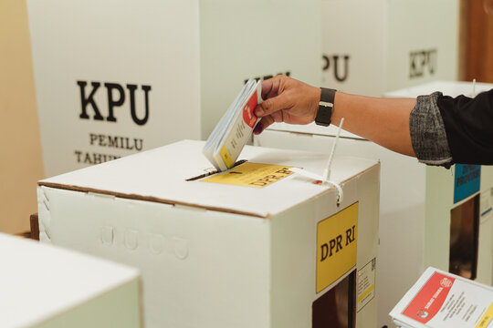 Resident put ballot paper in to a box during Indonesian Pemilu elections