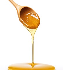Honey dripping from wooden spoon, isolated on white.