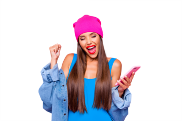 Charming and happy girl joyfully clasps her hand in a fist and holding the phone in her hands isolated on bright pink background