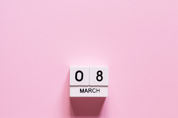 March 8 postcard. Wooden cubes number eight on a pink background. Happy Women's Day