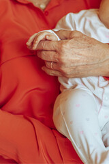 Baby in a Loving Grandmother's Arms - 735907997