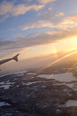 Sunset shining landscape on a white winter snowy Finnish lapland country from an airplane window view