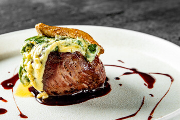 Grilled beef steak filet mignon with sauce in plate