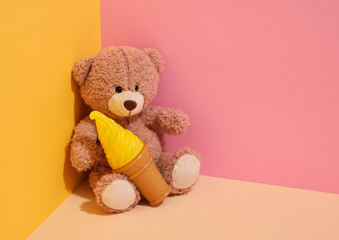 A soft teddy bear and delicious summer ice cream. Copy space for text.