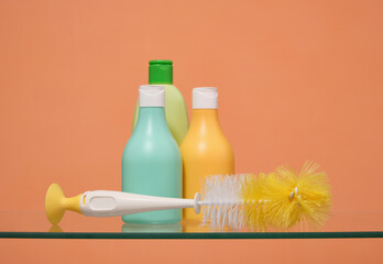 Colored bottles with various cleaning products and brush. Dishwashing and cleaning.