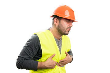 Builder in work uniform with indigestion having bellyache