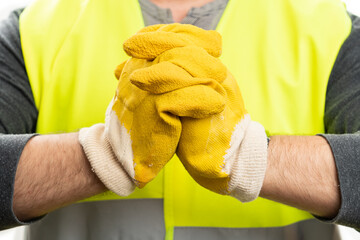 Selective focus close-up of builder with yellow work gloves