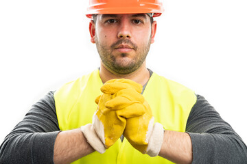 Close-up of serious builder wearing work gloves and helmet