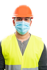 Male constructor wearing safety work attire with medical mask