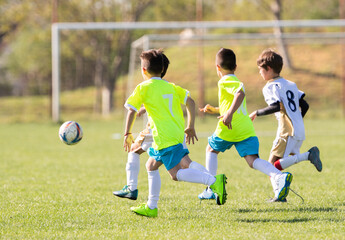 Boys play soccer sports field