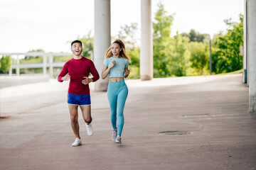 Fototapeta premium Multiethnic couple of friends exercising and joggingMultiethnic couple of friends exercising and jogging
