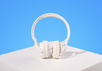 White headphones on the surface. Accessory for communication or music.