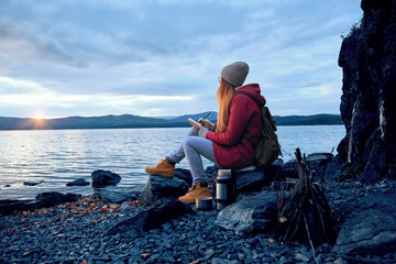 Traveler enjoying sunset scenic view over the mountains