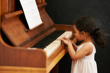 Piano, kid and toddler in home for learning, practice and classical education with musical notes....