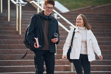 Obraz premium Having a break. Two young students are together outdoors