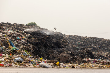 Piles of household waste are left on the side of the road. Dumping garbage in this way is polluting...
