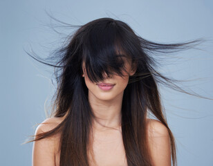 Studio, model and wind with long hair in eyes, mock up and keratin treatment for shine or salon...