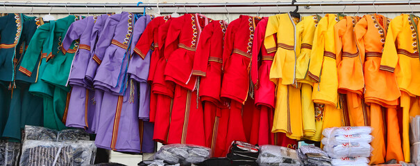 Ashgabat, Turkmenistan market. National Turkmen dresses with embroidery for girls - 735959781