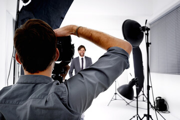 Back, model and photographer in studio, gear and pose with confidence and professional with...