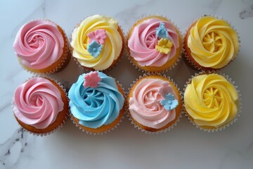 Colorful Cupcakes with Swirled Icing and Floral Decorations on Marble Surface
