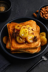 Toasted wheat bread with caramelized bananas, honey and almonds. Delicious healthy breakfast. Selective Focus