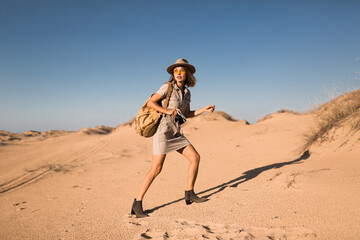 woman in desert walking on safari
