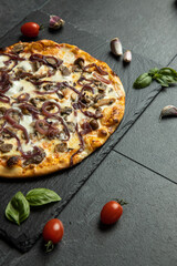 pizza menu on dark plate with stone texture