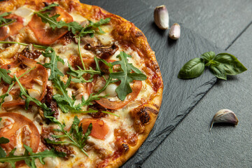 pizza menu on dark plate with stone texture