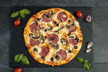 pizza menu on dark plate with stone texture
