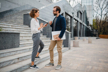 man and woman business partners working together