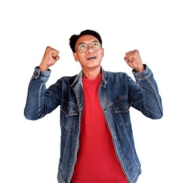 A young Asian man with a happy successful expression wearing navy blue shirt isolated on white background