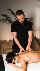 A professional masseur gives a massage to a young woman.Beautiful young woman enjoying massage in spa salon. Beauty treatment, skin care, wellbeing.Concept of massage and spa treatments