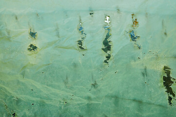 Torn green plastic cover background