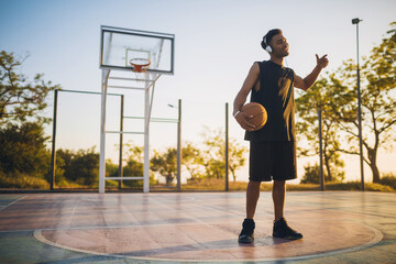 black man doing sports, playing basketball on sunrise, active lifestyle, sunny summer morning