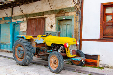Colorful vintage old antique yellow tractor