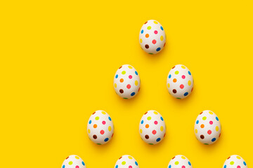 Spotty painted colorful easter eggs flat lay  on yellow background
