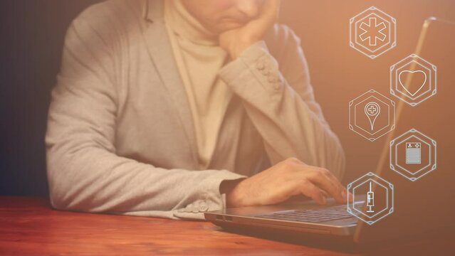 Cg footage with color correction on medical theme. Symbols of human life and health are located against the background of a thoughtful businessman in front of a laptop