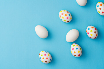 Fototapeta na wymiar Spotty painted easter eggs on blue background