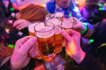 Group of friends celebrating with an alcoholic drinks. Glasses cheers, beer.