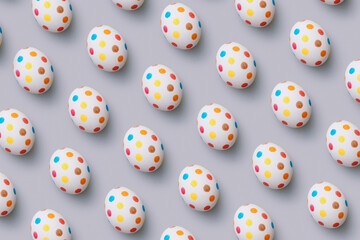 Spotty easter eggs flat lay on grey background.
